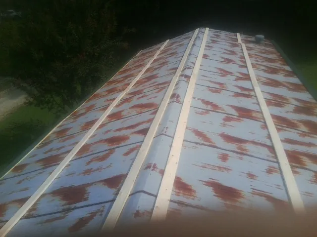 Rusted metal roof panels with new wood purlins before replacement — Storm Damage Roof Repair in Lufkin by Roofing Brothers